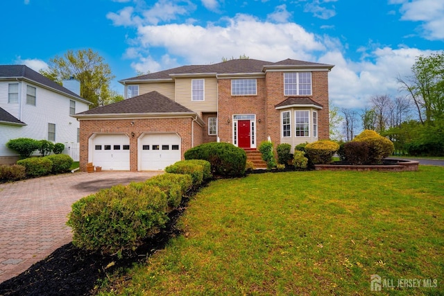 24 Chesapeake Rd, South Brunswick, NJ 08852 - traditional-style house featuring an attached garage, a front lawn, brick siding, and driveway