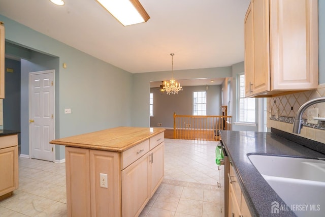 24 Chesapeake Rd, South Brunswick, NJ 08852 - kitchen featuring light tile patterned floors, light brown cabinetry, a sink, a notable chandelier, and tasteful backsplash