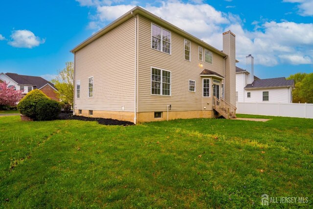24 Chesapeake Rd, South Brunswick, NJ 08852 - rear view of house with a yard, entry steps, and fence