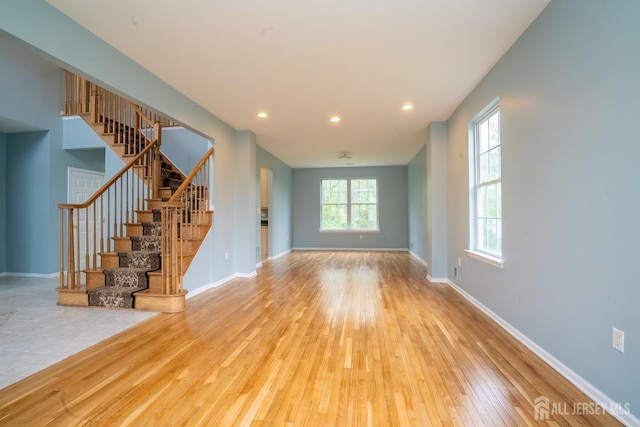 24 Chesapeake Rd, South Brunswick, NJ 08852 - unfurnished living room with stairway, hardwood / wood-style flooring, and baseboards