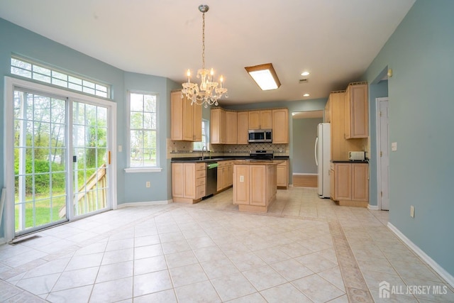 24 Chesapeake Rd, South Brunswick, NJ 08852 - kitchen with an inviting chandelier, dark countertops, appliances with stainless steel finishes, tasteful backsplash, and light tile patterned flooring