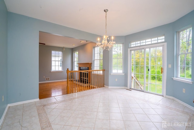 24 Chesapeake Rd, South Brunswick, NJ 08852 - empty room featuring baseboards, light tile patterned floors, and a healthy amount of sunlight