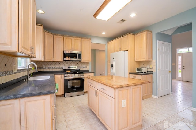24 Chesapeake Rd, South Brunswick, NJ 08852 - kitchen featuring a sink, stainless steel appliances, tasteful backsplash, visible vents, and light brown cabinetry