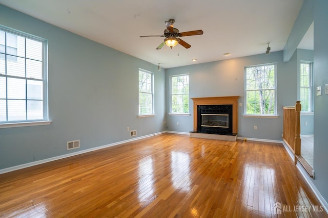 24 Chesapeake Rd, South Brunswick, NJ 08852 - unfurnished living room with visible vents, baseboards, ceiling fan, and hardwood / wood-style flooring