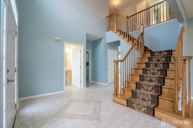24 Chesapeake Rd, South Brunswick, NJ 08852 - stairway with tile patterned flooring, baseboards, and a high ceiling