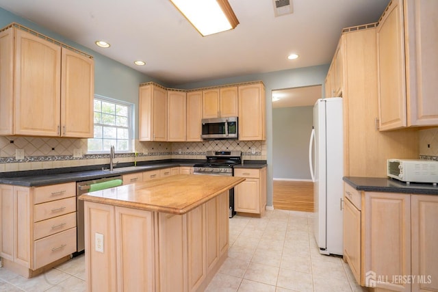 24 Chesapeake Rd, South Brunswick, NJ 08852 - kitchen with a sink, stainless steel appliances, light brown cabinetry, and visible vents