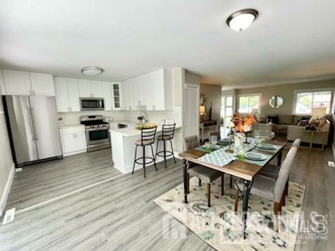 dining area featuring light wood-type flooring