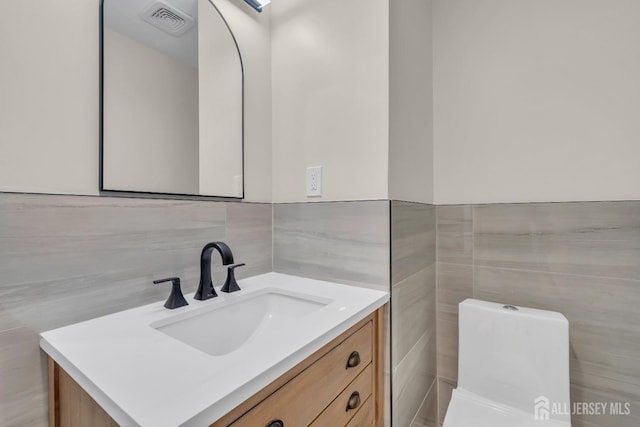 bathroom featuring tile walls and vanity