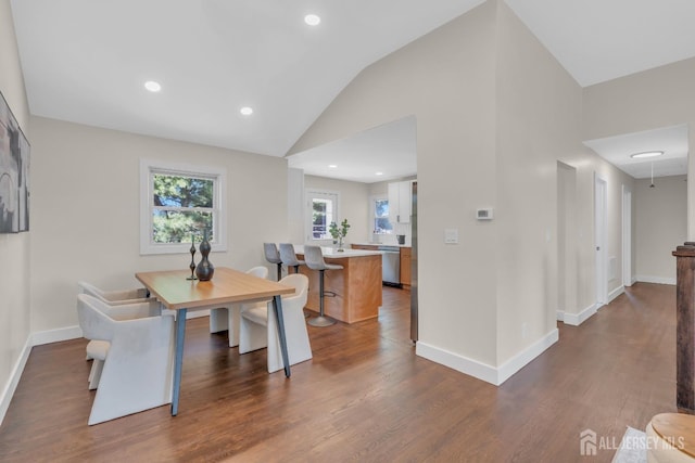 dining space with vaulted ceiling, dark wood-style floors, baseboards, and recessed lighting