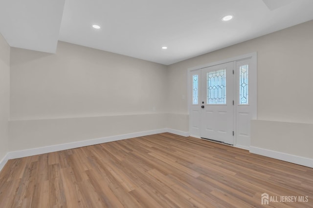 entryway with wood finished floors, baseboards, and recessed lighting