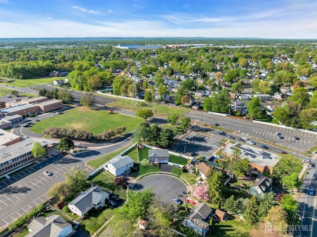 aerial view of property and surrounding area featuring nearby suburban area
