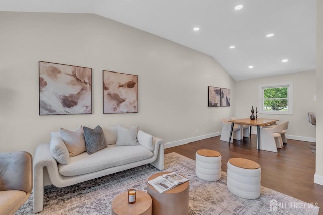 living room featuring lofted ceiling, dark wood-type flooring, recessed lighting, and baseboards