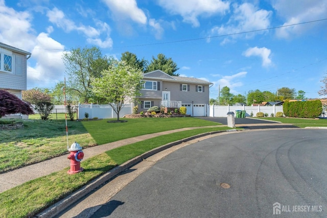 split foyer home featuring driveway and a garage