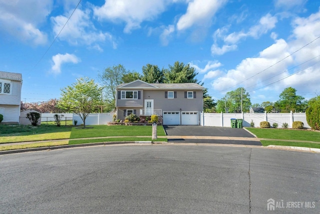 split foyer home with driveway and an attached garage