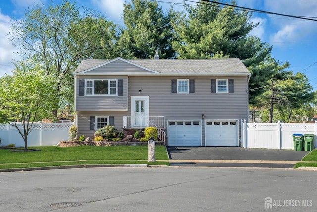 split foyer home with driveway and a garage