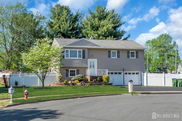 split foyer home featuring asphalt driveway and an attached garage