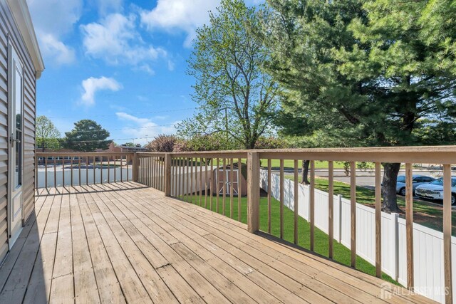 wooden terrace with a shed and an outbuilding