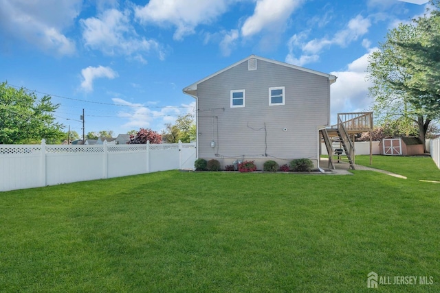 view of side of home with stairs, a shed, an outbuilding, and a deck