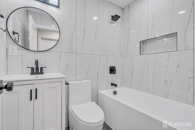 bathroom featuring tile walls, vanity, toilet, and  shower combination