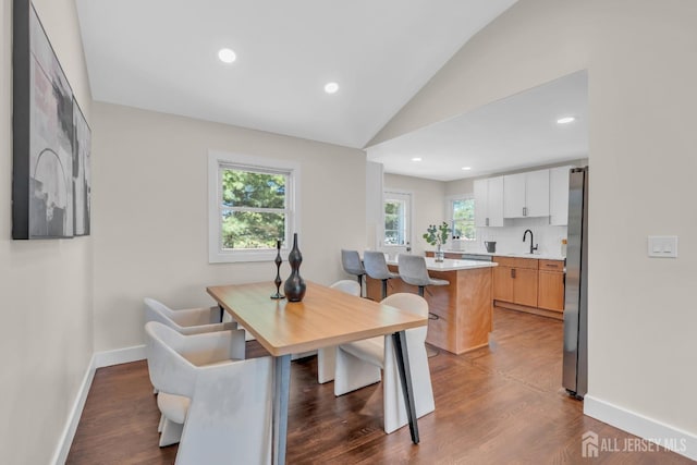 dining area featuring vaulted ceiling, wood finished floors, baseboards, and recessed lighting