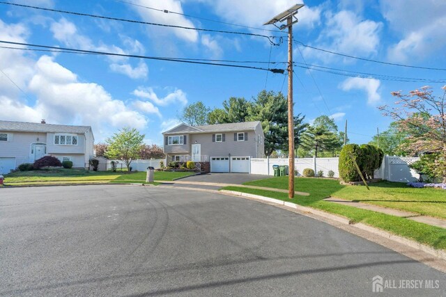 split foyer home with an attached garage and driveway
