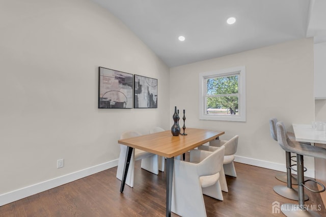 dining room featuring vaulted ceiling, baseboards, dark wood-style flooring, and recessed lighting