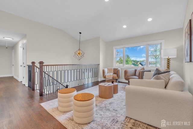 living room with dark wood-style flooring, vaulted ceiling, baseboards, and recessed lighting