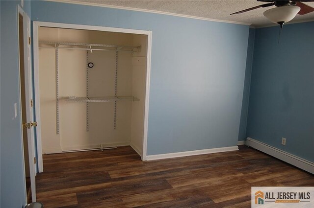 unfurnished bedroom with a textured ceiling, baseboard heating, a closet, and wood finished floors