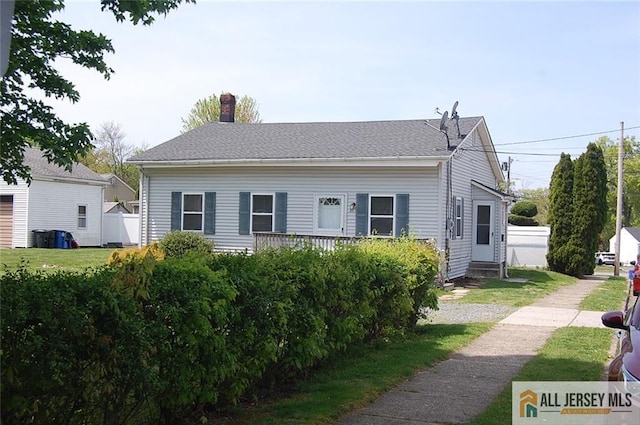 bungalow featuring fence, a chimney, and entry steps