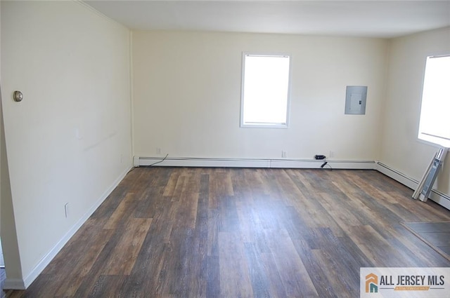empty room featuring baseboards and wood finished floors