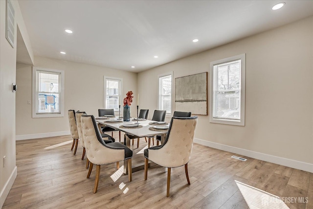 dining space with light hardwood / wood-style flooring