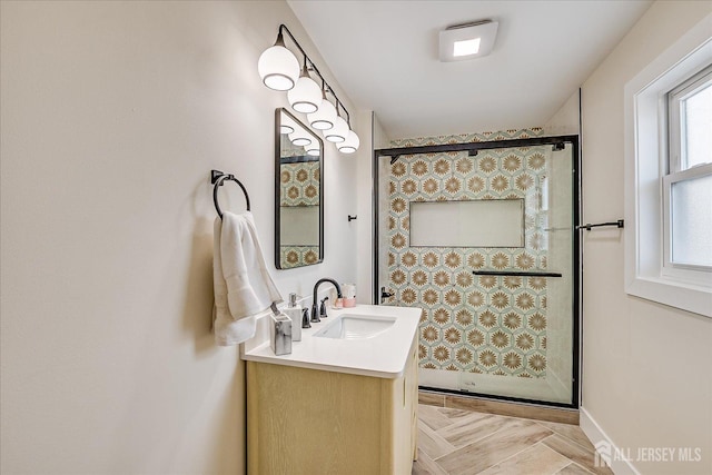 bathroom featuring walk in shower and vanity