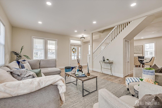 living room with a wealth of natural light and light hardwood / wood-style floors