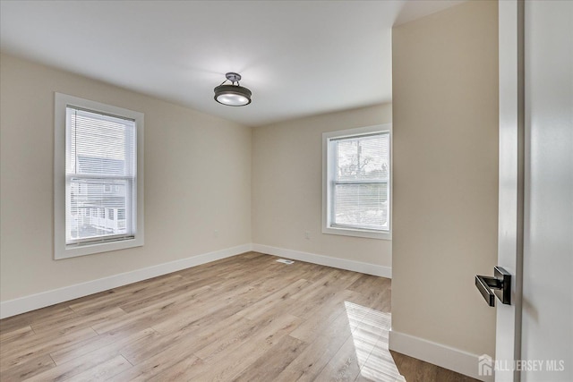 spare room with light wood-type flooring