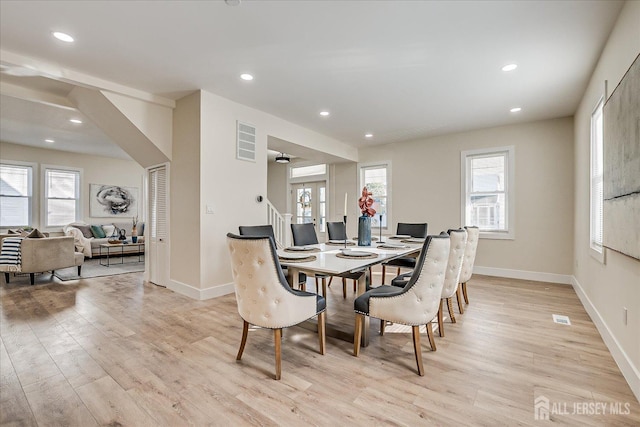 dining space featuring light wood-type flooring and french doors