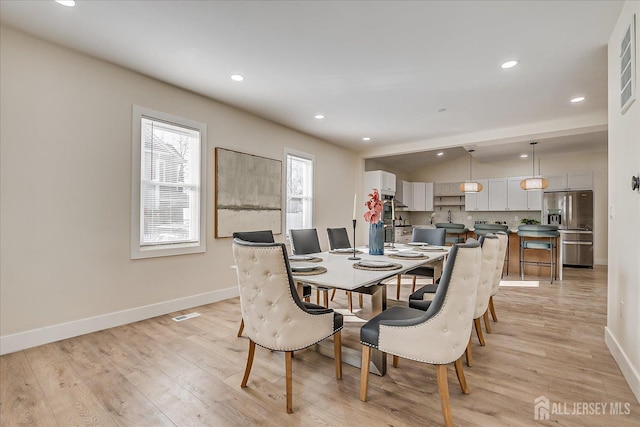 dining space featuring light wood-type flooring