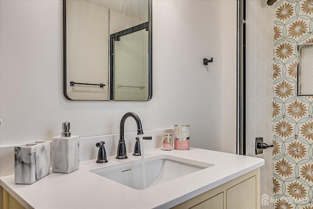 bathroom with walk in shower and vanity