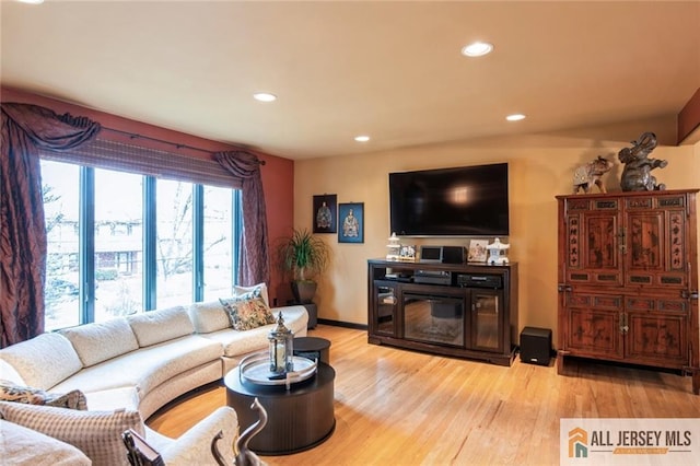 living area with baseboards, recessed lighting, and wood finished floors