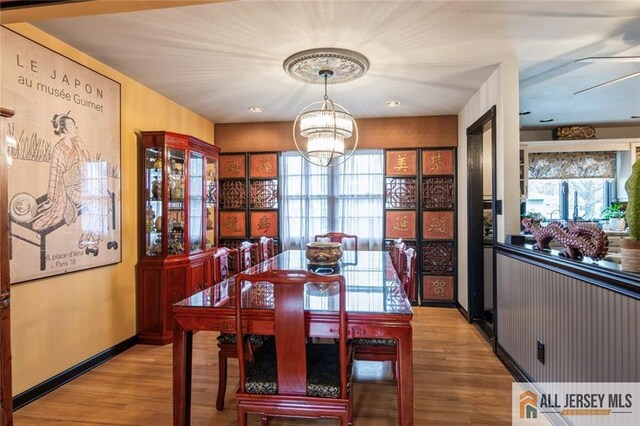 dining space featuring a chandelier and wood finished floors
