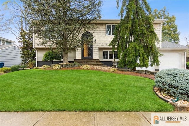 split foyer home featuring a front yard and an attached garage