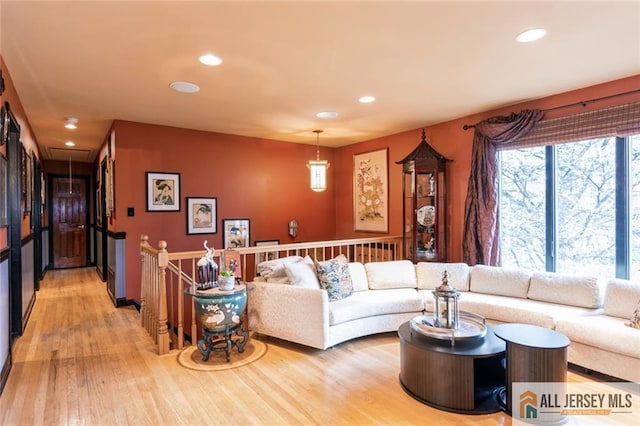 living area with recessed lighting, light wood-style flooring, and attic access