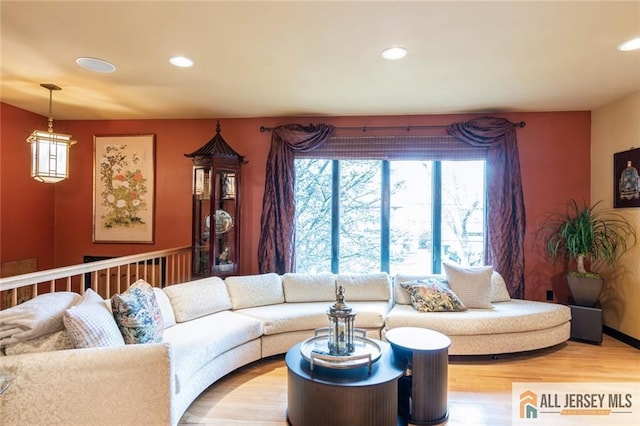 living room featuring light wood-style flooring and recessed lighting