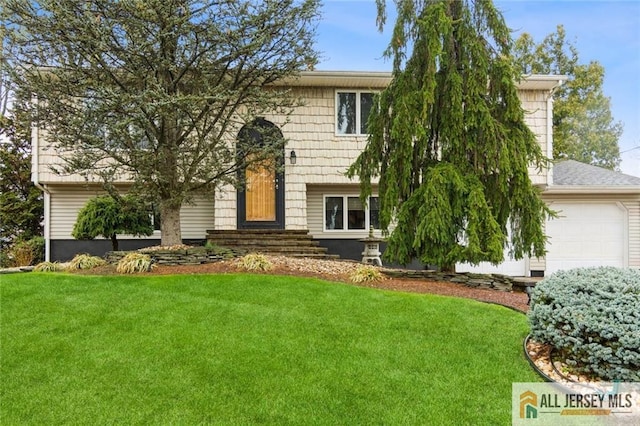 bi-level home with a front yard and an attached garage