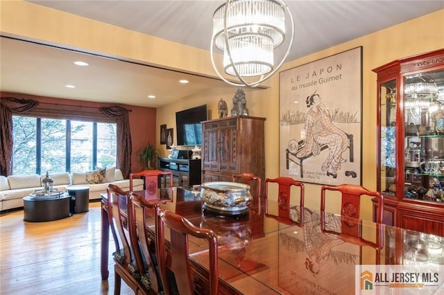 dining room featuring wood finished floors, an inviting chandelier, and recessed lighting