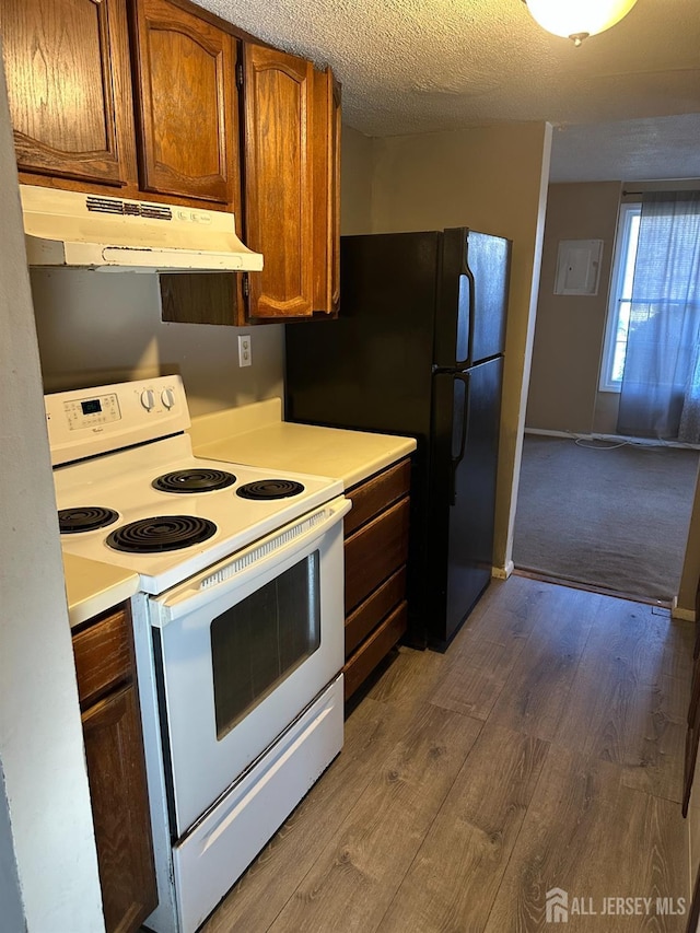 kitchen featuring hardwood / wood-style floors, a textured ceiling, and white range with electric stovetop