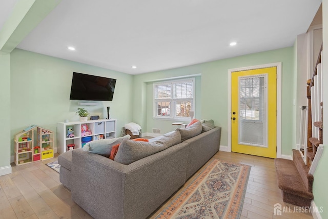 living room with light wood-type flooring, baseboards, and recessed lighting