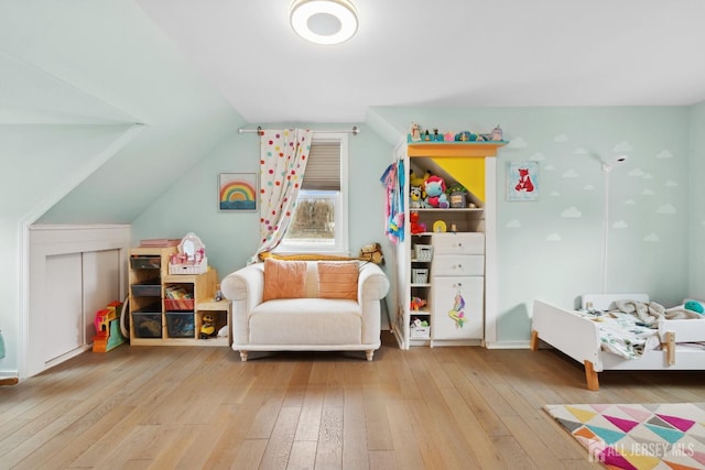 rec room featuring lofted ceiling and wood finished floors