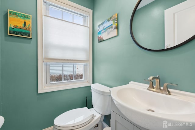 half bathroom with vanity and toilet