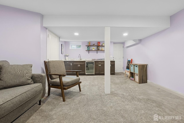 living room featuring wine cooler, indoor wet bar, recessed lighting, light colored carpet, and baseboards