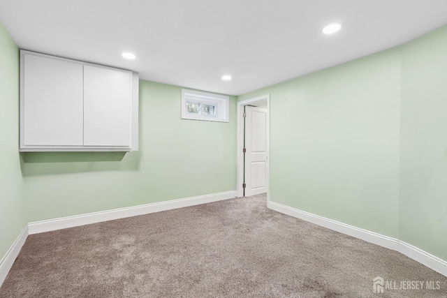 carpeted spare room featuring recessed lighting and baseboards